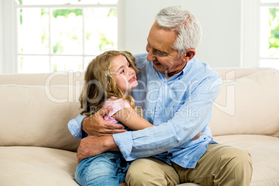 Smiling granddad hugging girl