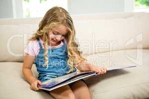 Smiling girl with picture book