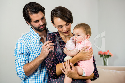 A Couple is posing with a baby