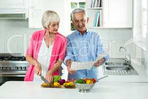 Happy senior couple with recipe book