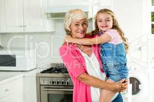 Portrait of smiling granny carrying girl