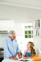 Granddad helping girl with homework