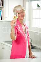 Portrait of smiling senior woman holding white wine