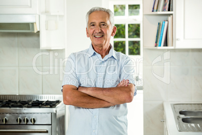 Smiling senior man with arms crossed
