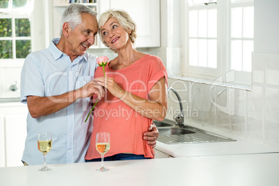 Smiling senior couple with rose