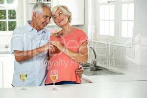 Smiling senior couple with rose