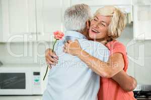 Smiling senior woman hugging man
