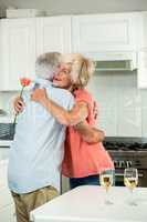 Happy senior woman hugging man