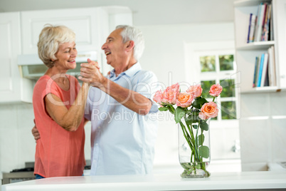 Cheerful retired couple dancing