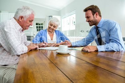 Senior couple discussing with agent