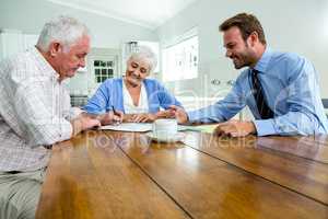 Senior couple discussing with agent