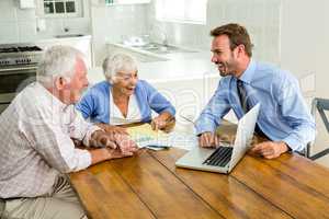 Couple laughing with agent sitting at table