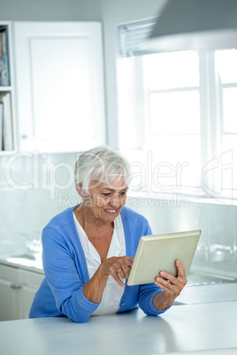 Happy senior woman using tablet pc