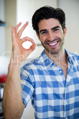 Portrait of man showing hand ok sign