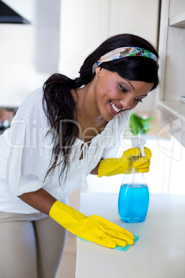 Happy woman cleaning the kitchen