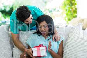 Man giving a surprise gift to woman