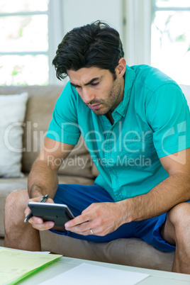 Man accounting the bills with calculator