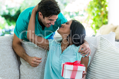 Man giving a surprise gift to woman