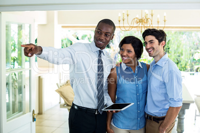 Real estate agent showing the house to couple