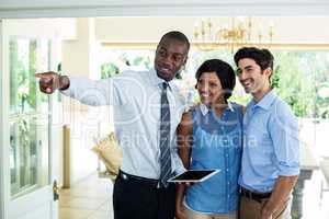 Real estate agent showing the house to couple