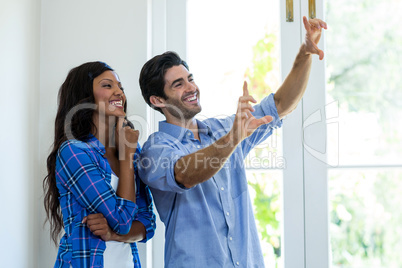 Couple framing a picture with hands