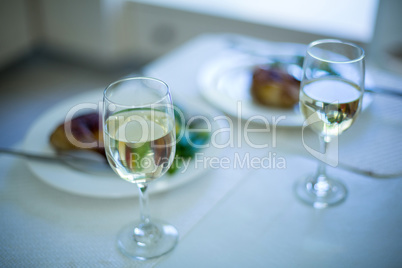 Two wine glasses and meal on table