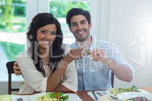 Portrait of couple toasting wine glasses