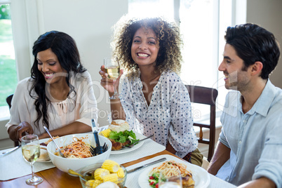 Happy friends having meal together