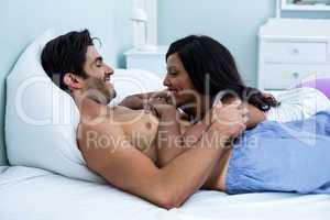 Romantic couple lying together on bed