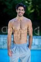 Young man standing near pool
