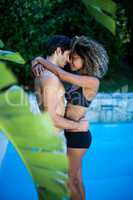 Young couple standing near swimming pool