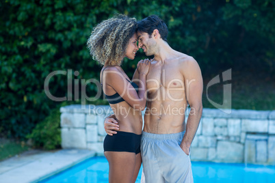 Young couple standing near swimming pool