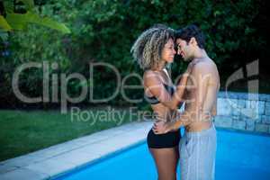 Young couple standing near swimming pool