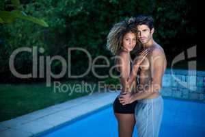 Young couple standing near swimming pool