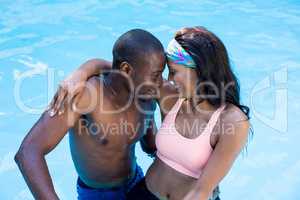 Young couple enjoying in the swimming pool