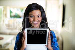 Young woman showing digital tablet