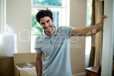 Young man standing in his new house