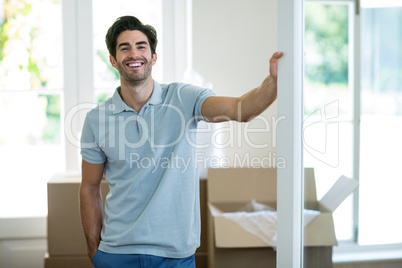 Young man standing in his new house