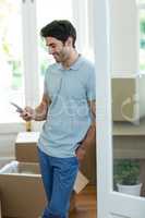 Young man text messaging on mobile phone