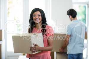 Young couple carrying cardboard box