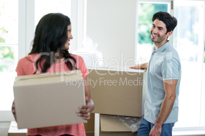 Young couple carrying cardboard box