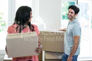 Young couple carrying cardboard box