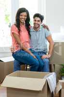 Young woman sitting on lap of a man and smiling at camera