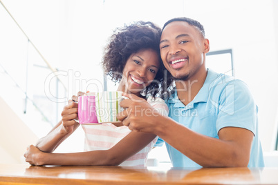 Happy couple toasting coffee mug