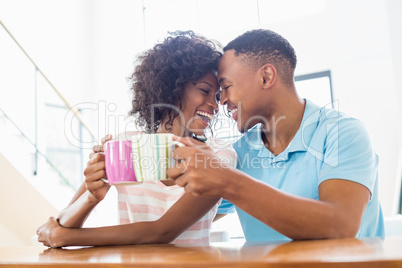 Happy couple toasting coffee mug