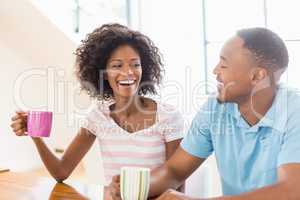 Happy couple holding coffee mug