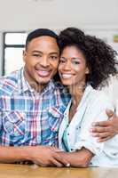 Young couple embracing each other in kitchen