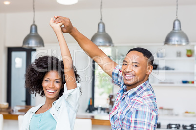 Happy couple dancing in kitchen