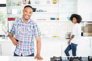Portrait of young couple standing in kitchen