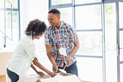 Young couple unpacking carton boxes